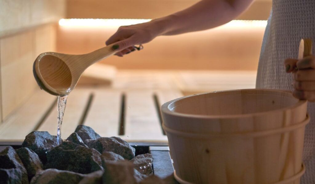 Water being poured on rocks in Sauna
