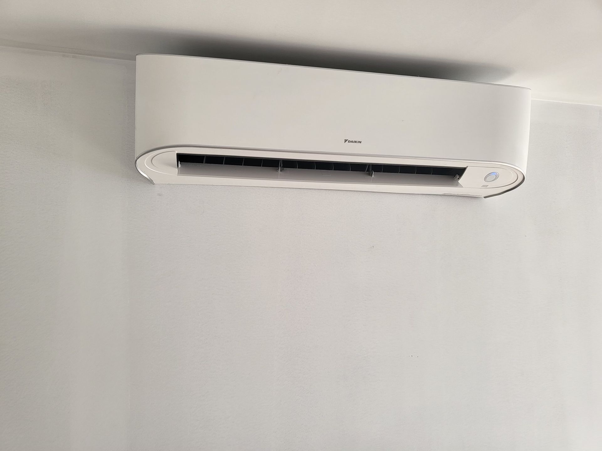 White wall-mounted air conditioning unit.