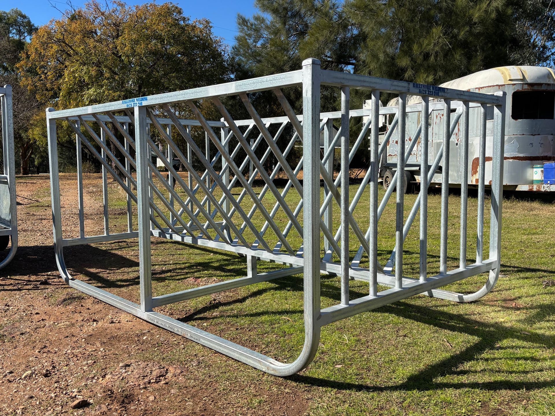 A Bunch of Metal Crates Are Sitting on Top of A Dirt Field — Ballimore Welding in Ballimore, NSW