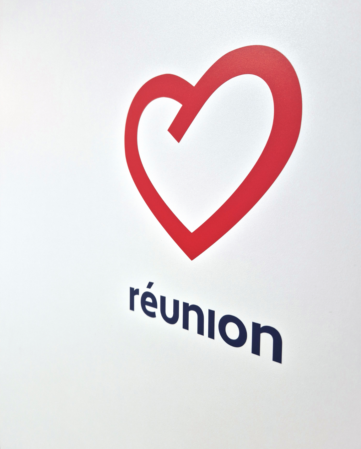Red heart logo with a blue 