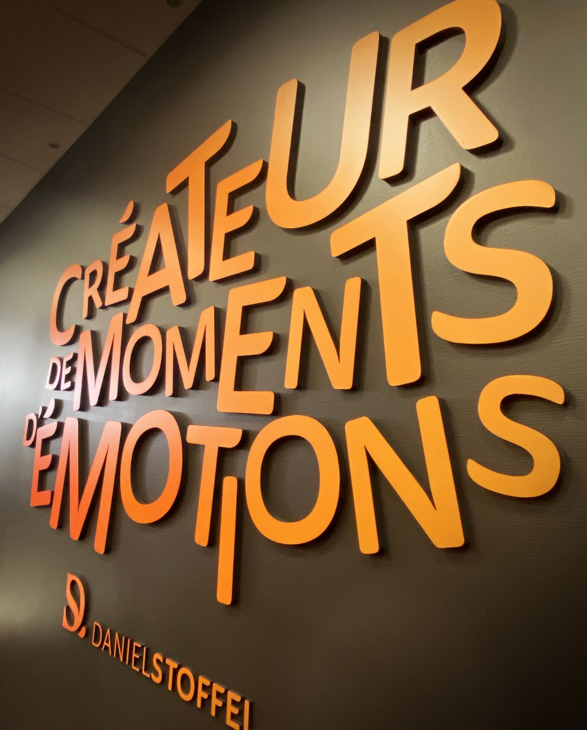 Orange lettering on a dark wall: 