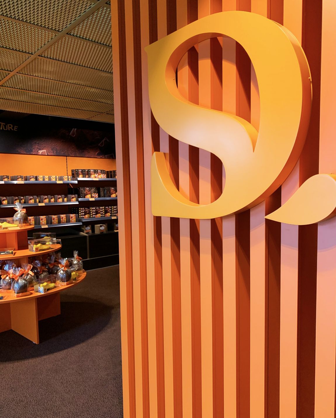 Orange-toned shop entrance with a large 