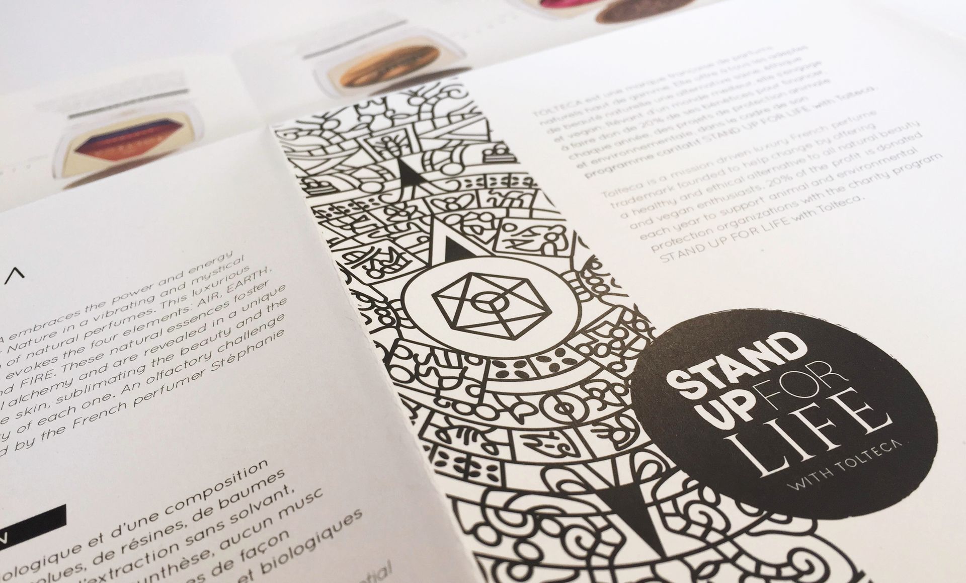 Open book with black and white illustrations and text. Includes a logo with the words 