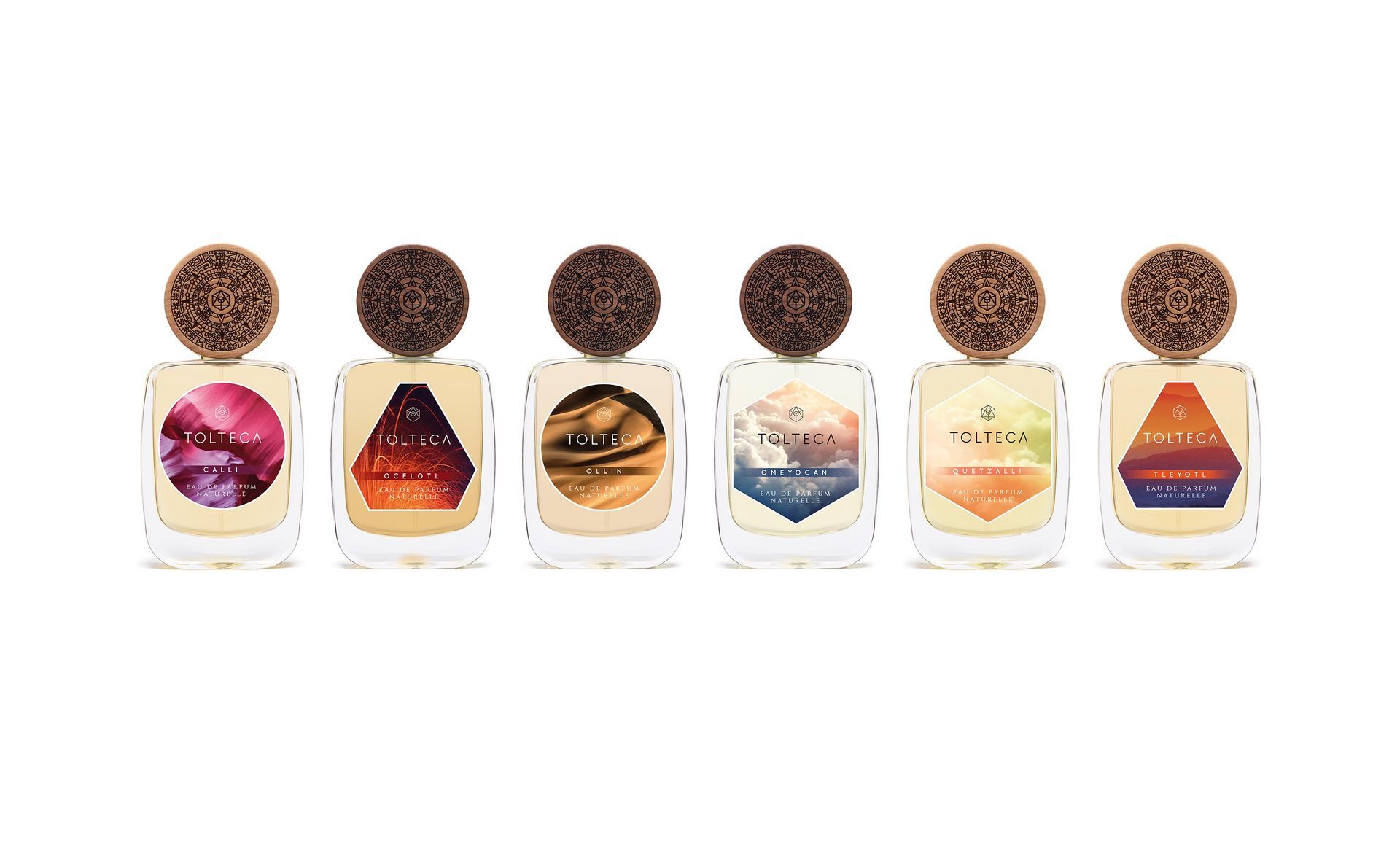 Six perfume bottles with colorful geometric label designs and textured brown stoppers.