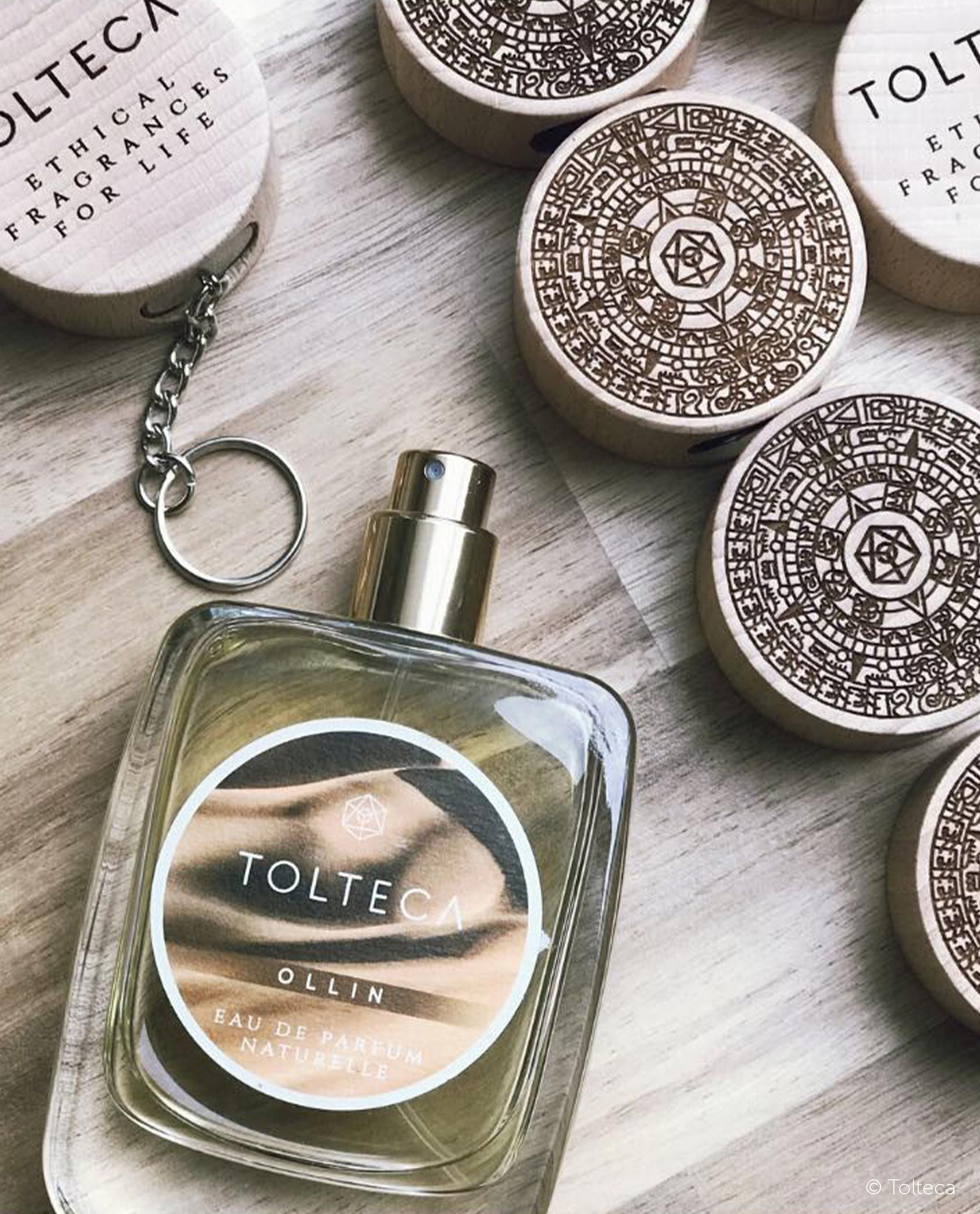 Perfume bottle and wooden containers with QR codes, labeled 