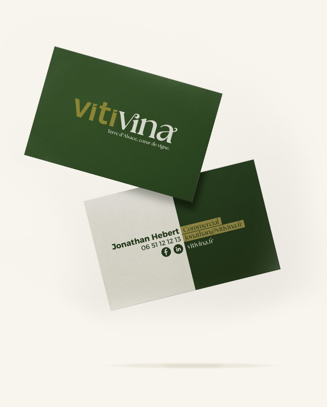Two business cards: one green with gold text 