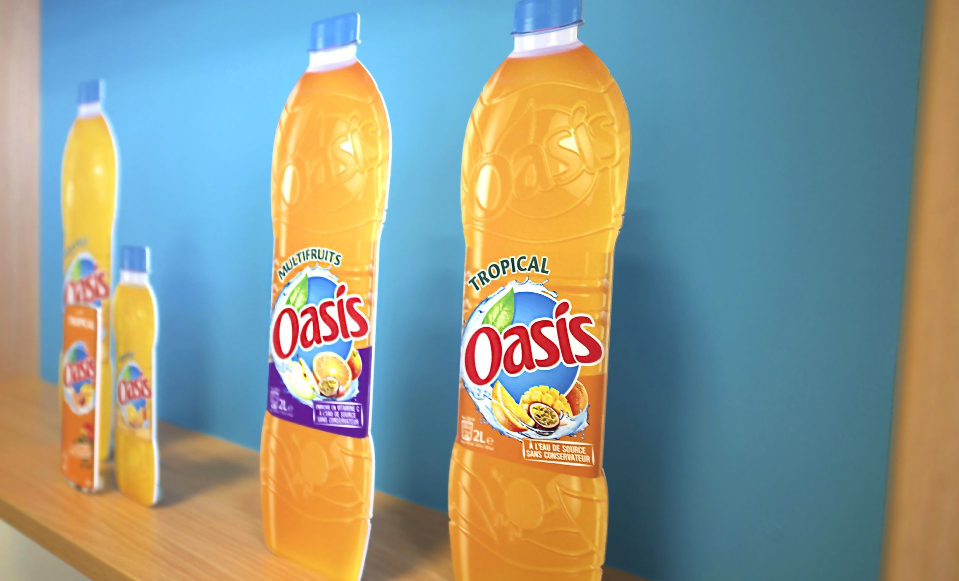 Bottles of Oasis fruit juice in various sizes lined up on a shelf against a blue backdrop.