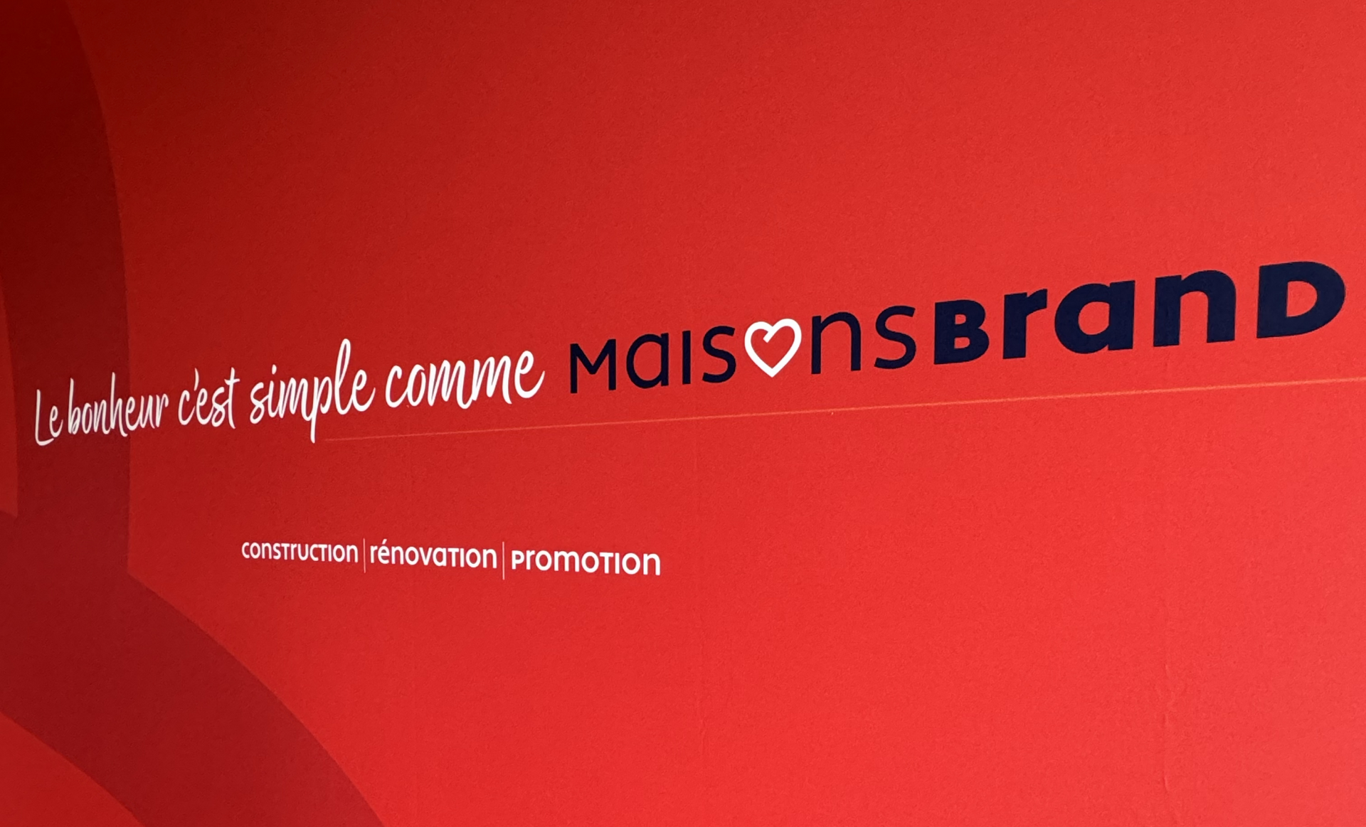 Red wall with white text: 