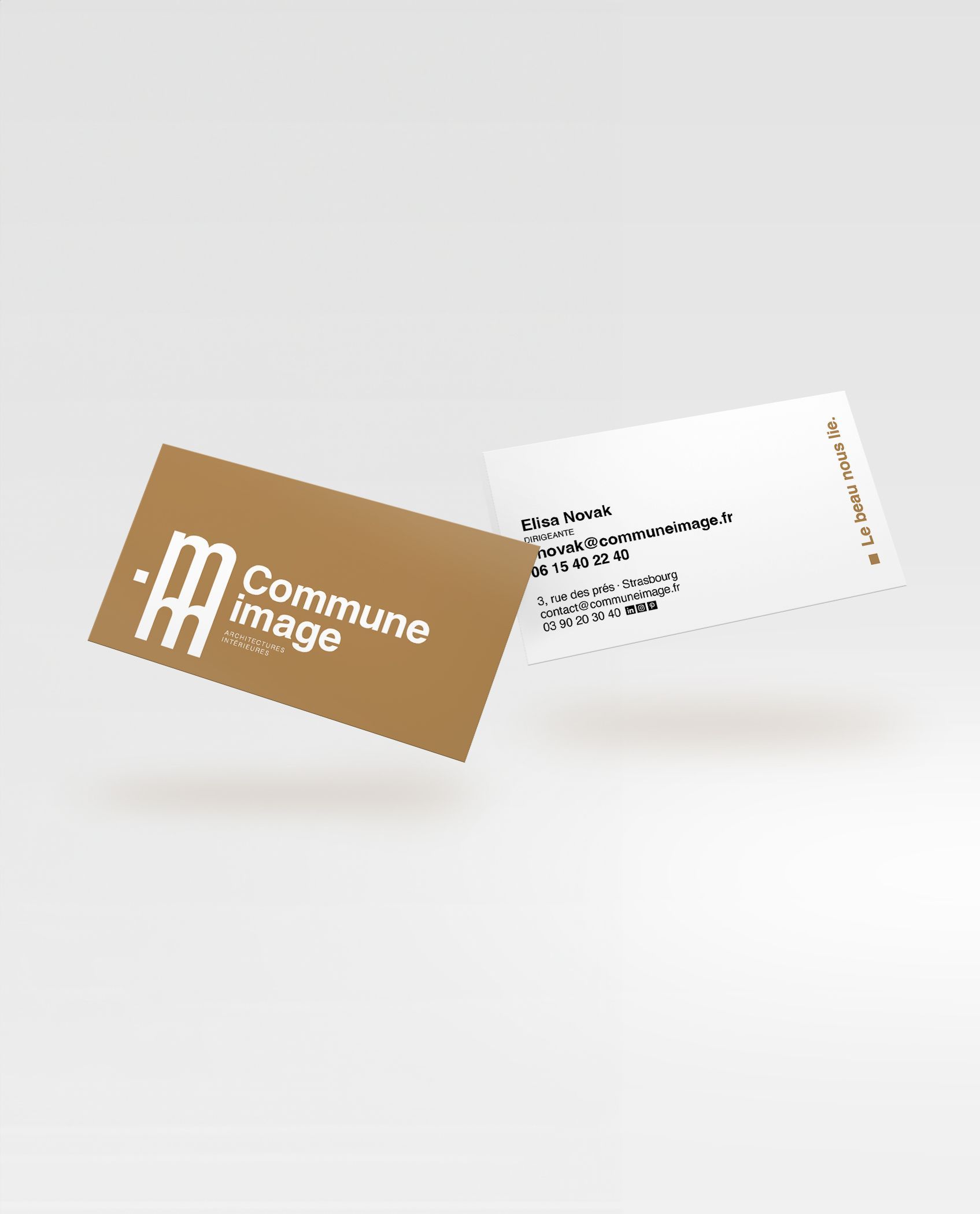 Two business cards: one gold, with a logo and company name; the other white, with contact details.