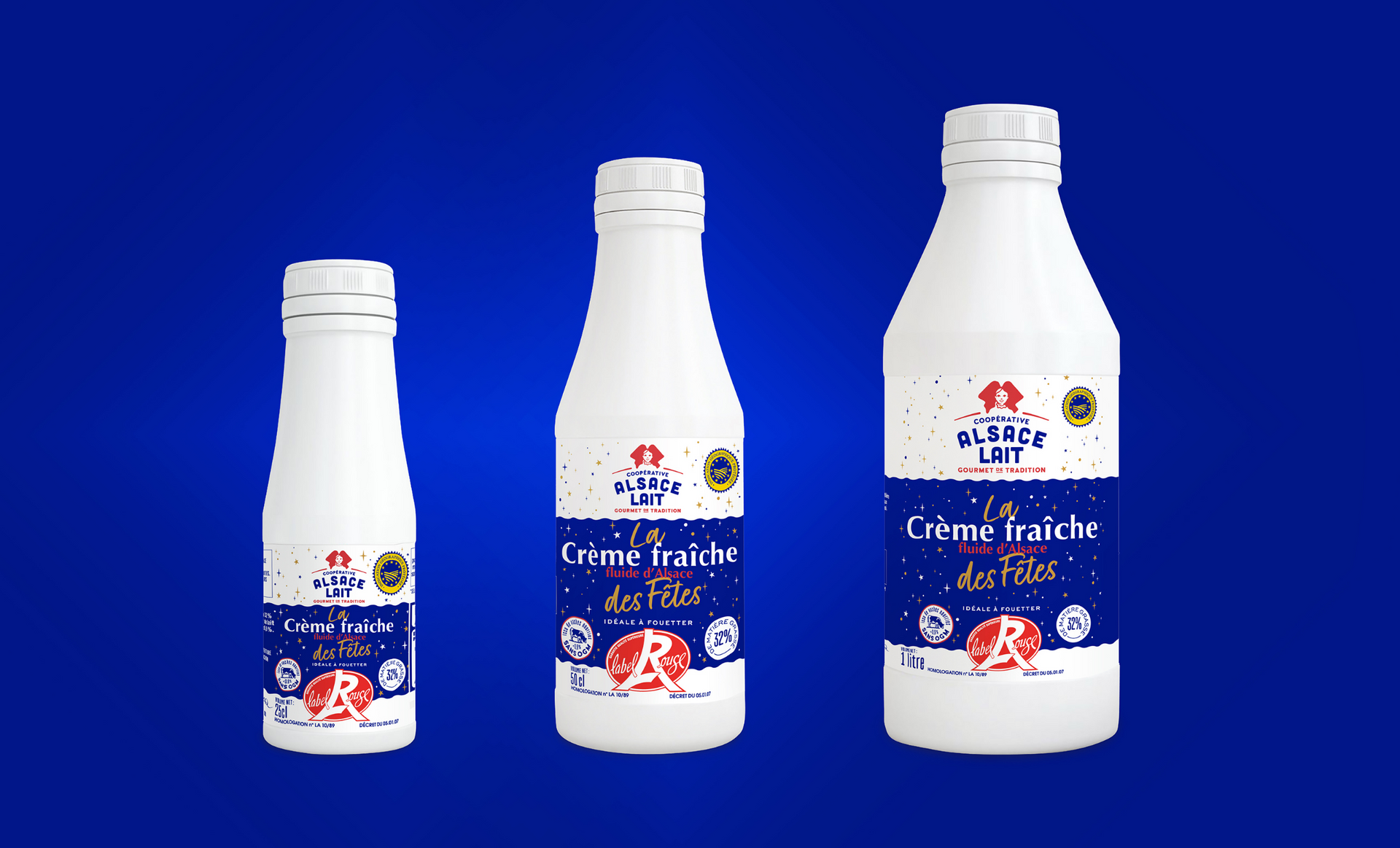 Three white bottles of creme fraiche with blue and red labels on a blue background.