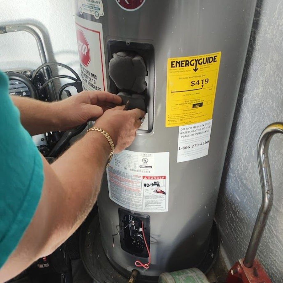 A person is cleaning a water filter next to a water tank.
