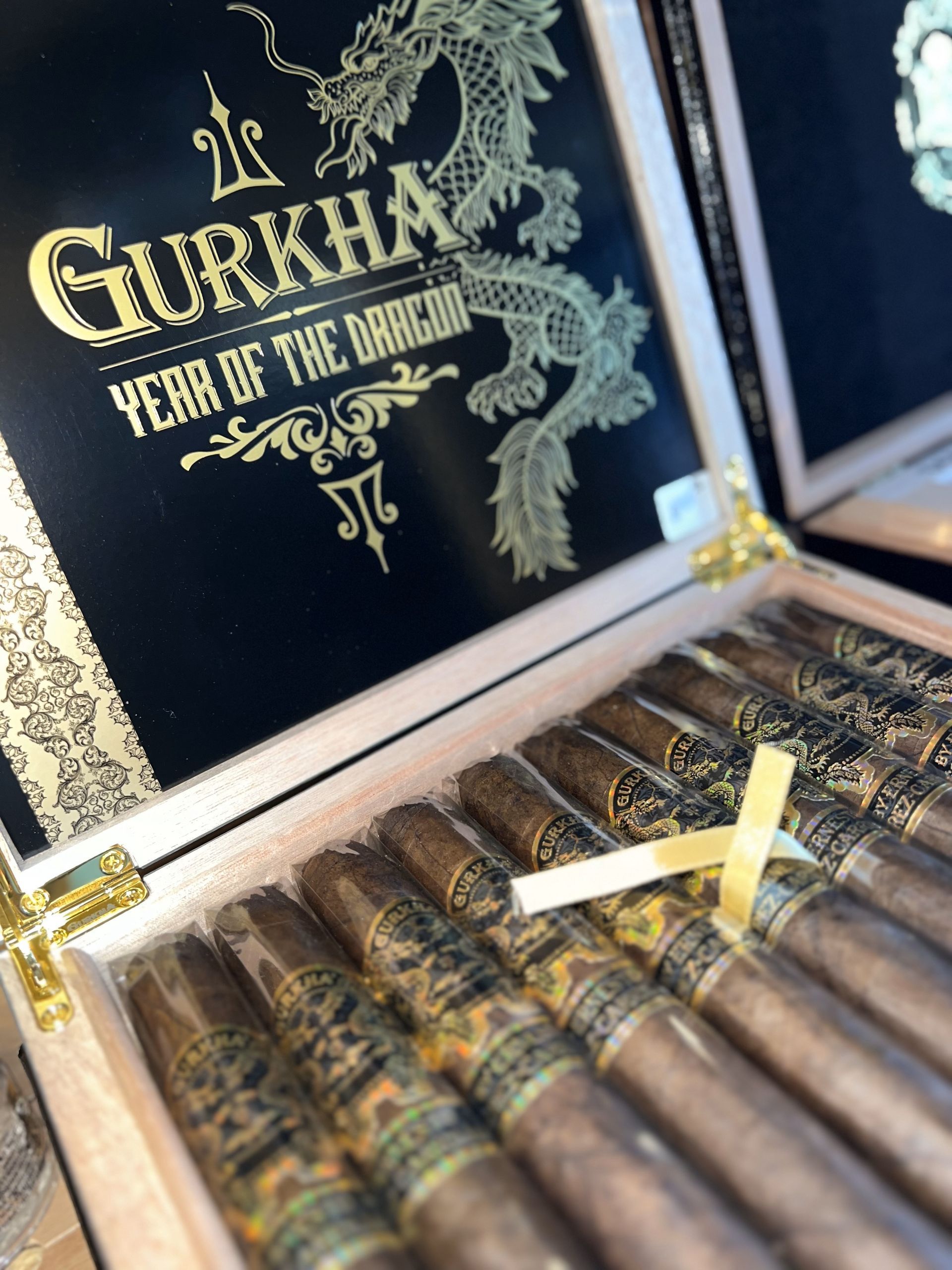 Open cigar box with Gurkha Year of the Dragon cigars and gold lettering on black lining