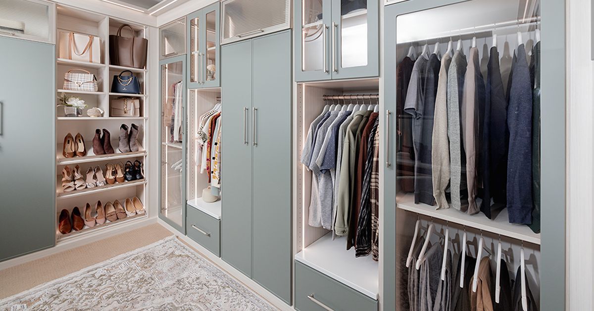 Walk-in closet with clothes hanging, shelves with shoes and bags, neutral colors.