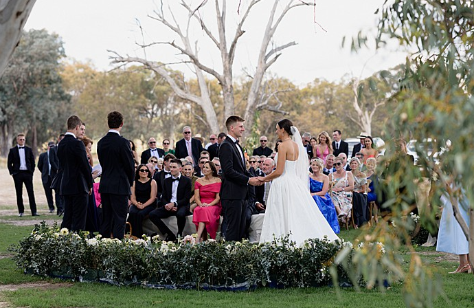 photo taken from behind the couple looking at all the guests faces