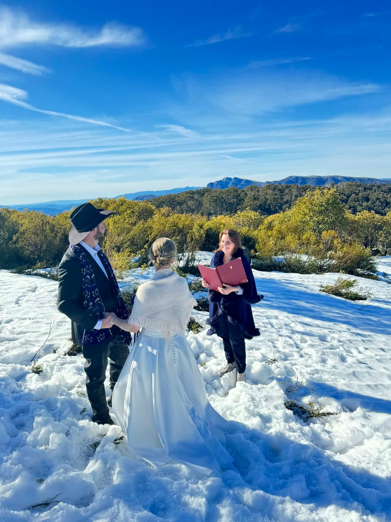 Couple being married by the skiing celebrant in the snow with Cheryl Warry