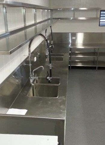 A Kitchen with Stainless Steel Counter Tops and Sinks — Manufacturing Design Engineering in Garbutt QLD
