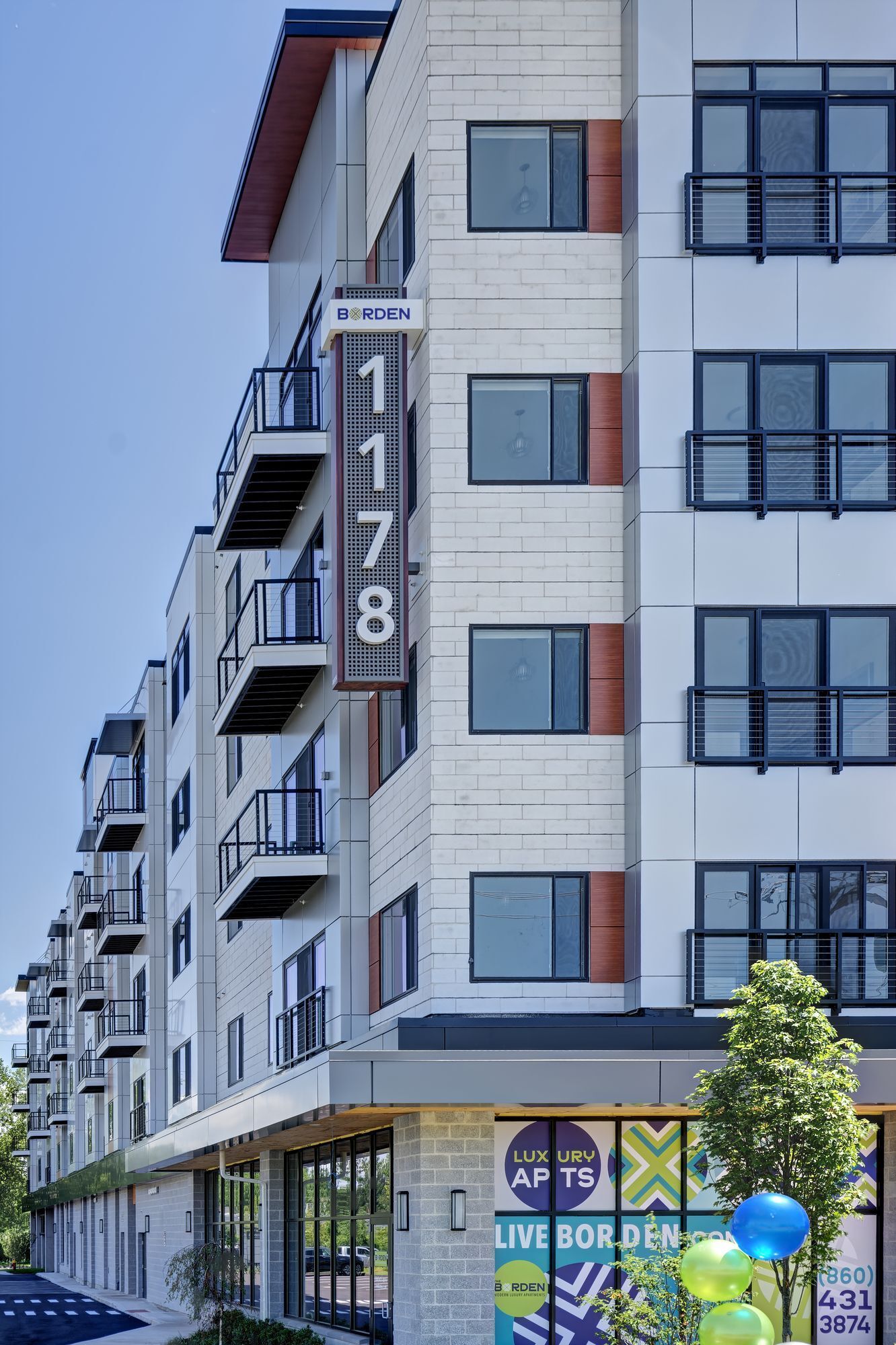 A large apartment building with a sign that says 1178 on it.