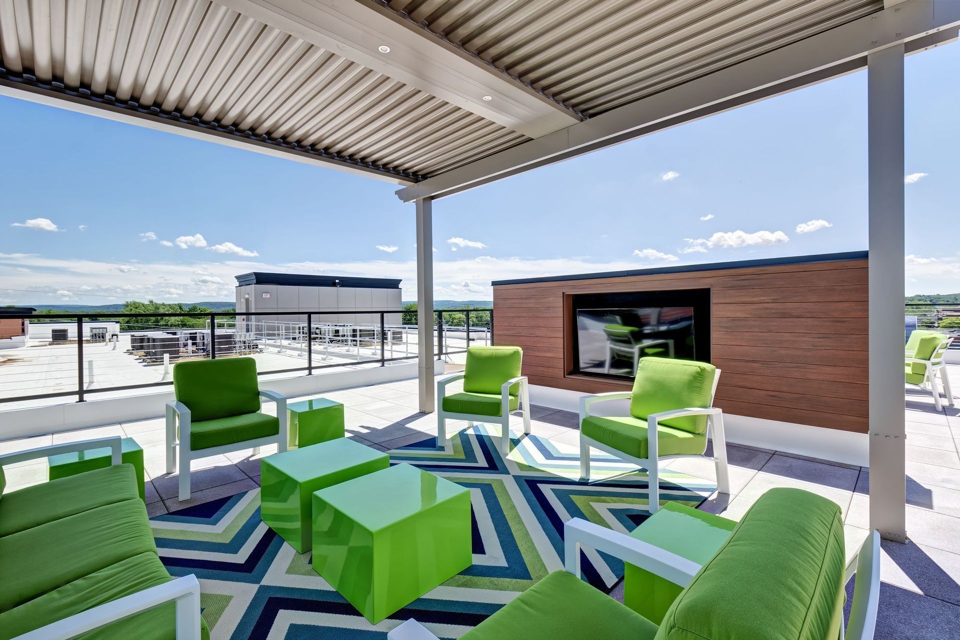 A group of chairs and a fire pit in front of a building