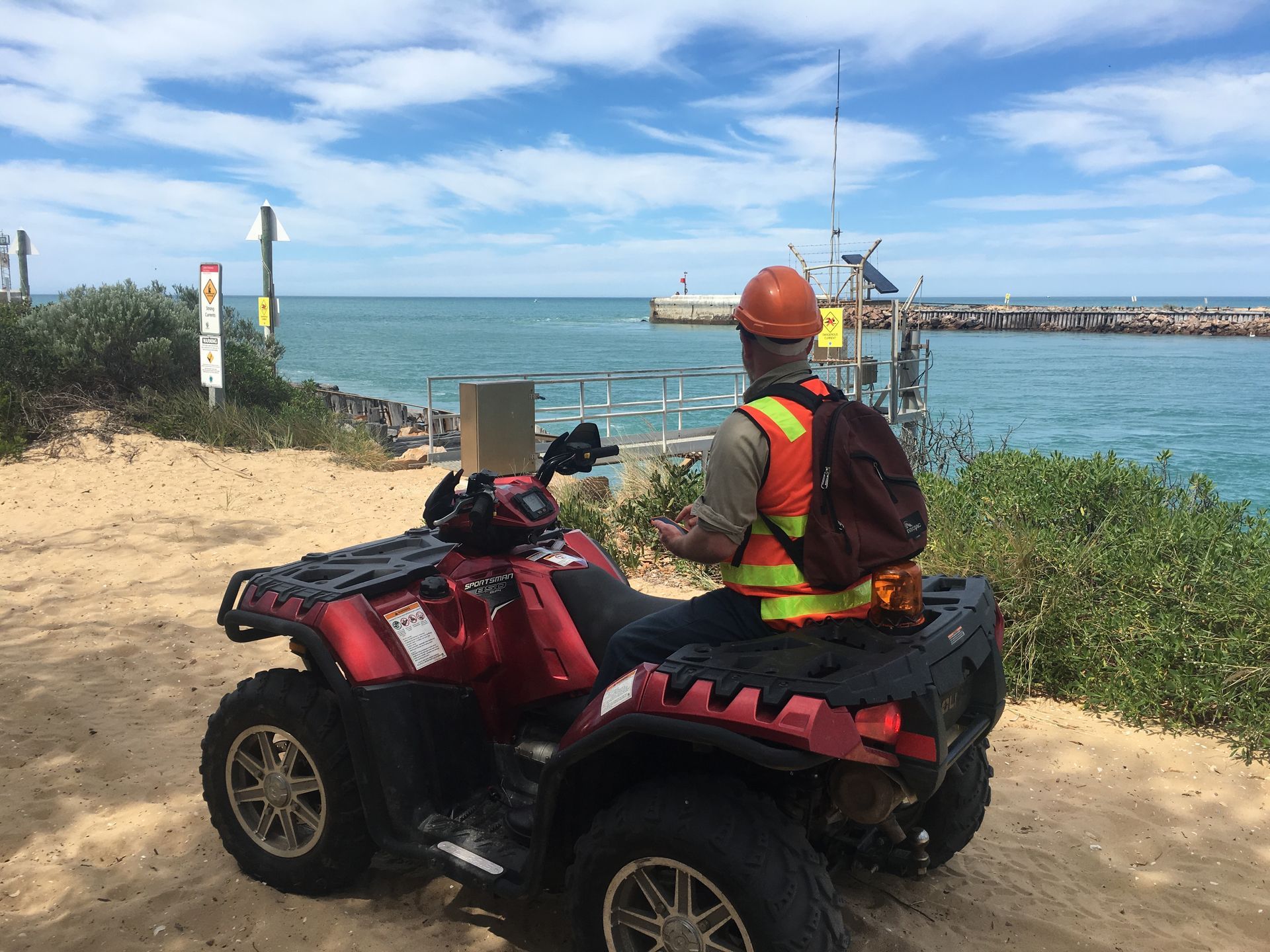 Person On Atv Overlooking The Ocean.
