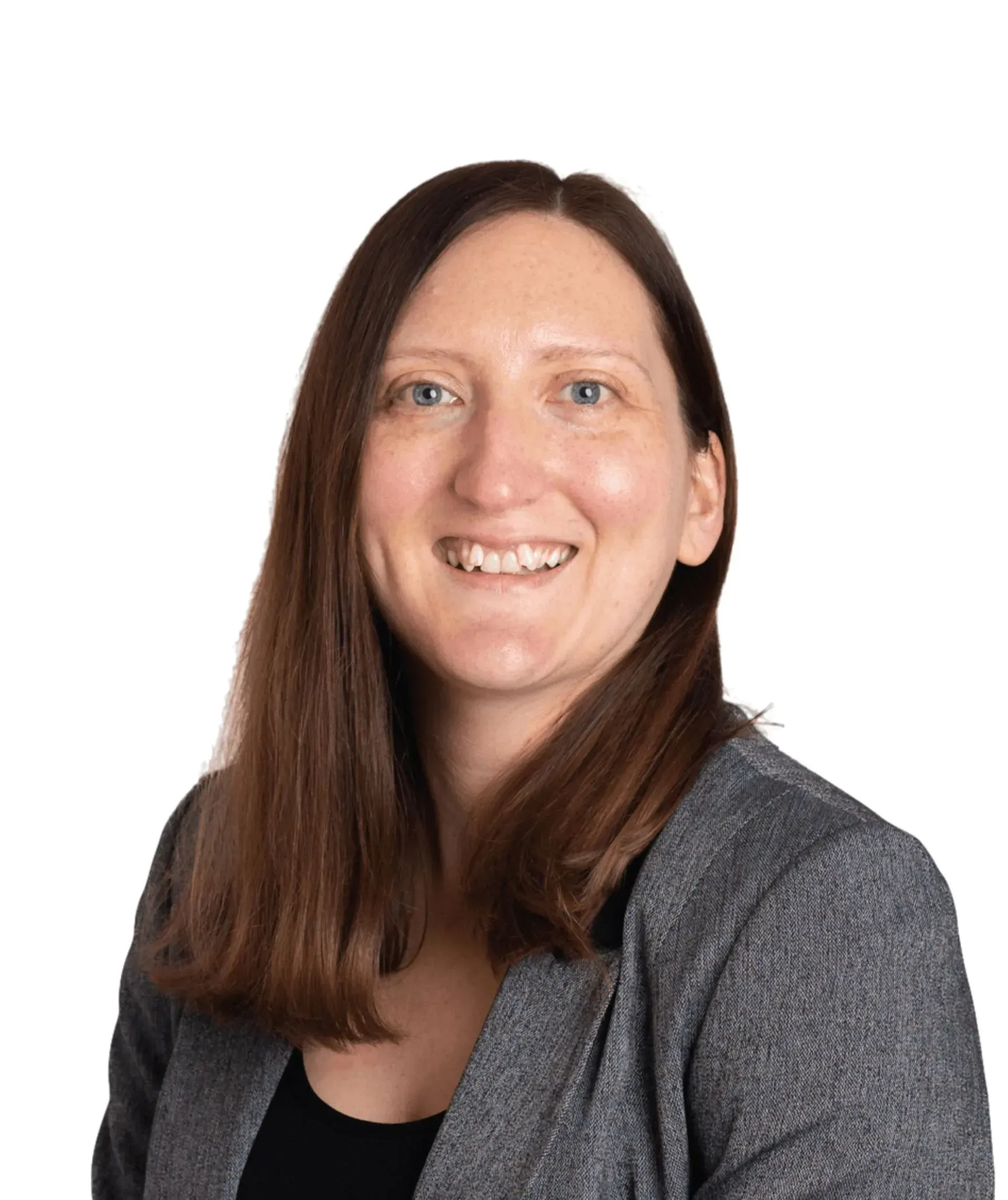 A smiling person with long brown hair wearing a grey blazer against a plain white background.