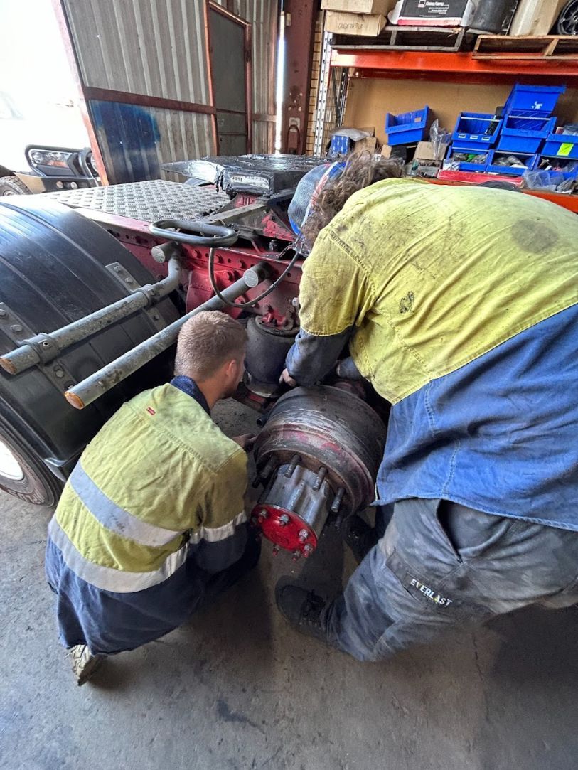 Two Men Are Working on a Truck in a Garage — Trucks On The Run Pty Ltd in Charlton, QLD