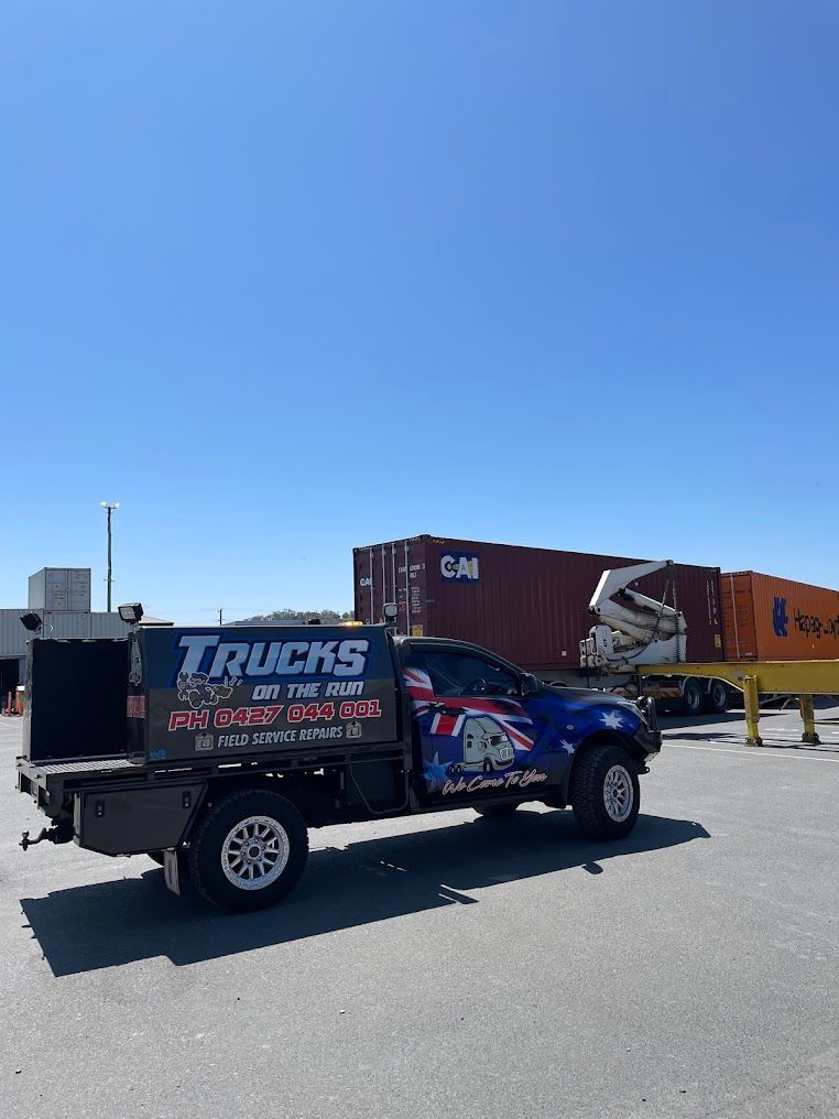 A Truck is Parked in a Parking Lot Next to a Shipping Container — Trucks On The Run Pty Ltd in Wellcamp, QLD