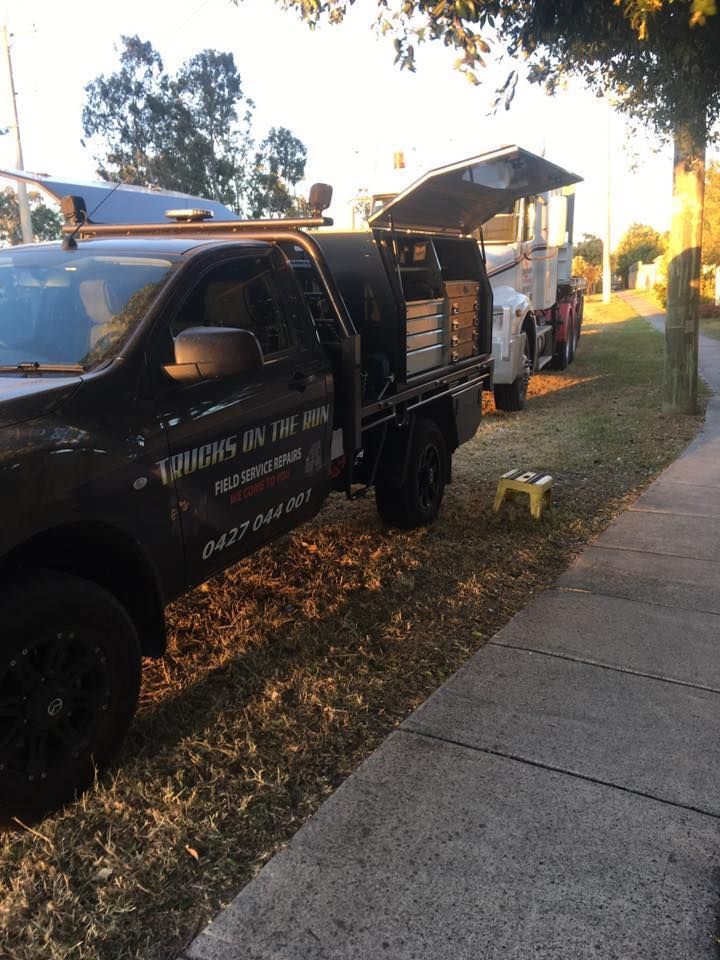 A Black Truck is Parked on the Side of the Road Next to a Sidewalk — Trucks On The Run Pty Ltd in Highfields, QLD 