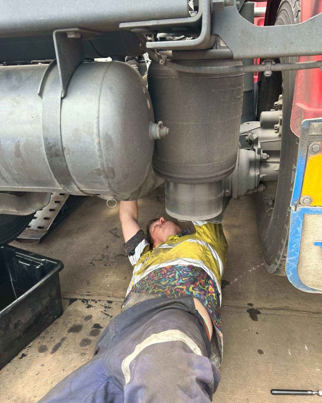 A Man is Working Underneath a Truck — Trucks On The Run Pty Ltd in Wilsonton, QLD