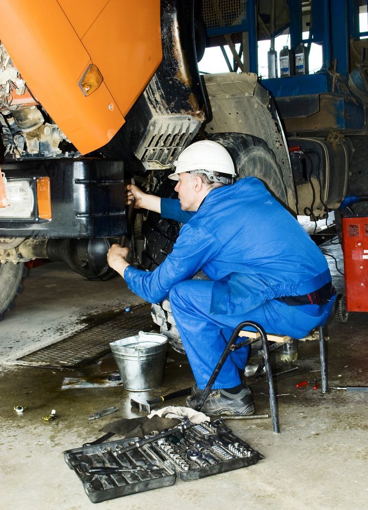 A Man is Working on a Truck in a Garage — Trucks On The Run Pty Ltd in Westbrook, QLD