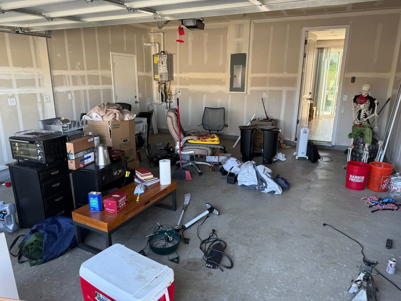 Garage Cleanouts in Butte County, CA — before: cluttered garage interior with tools, boxes and bikes