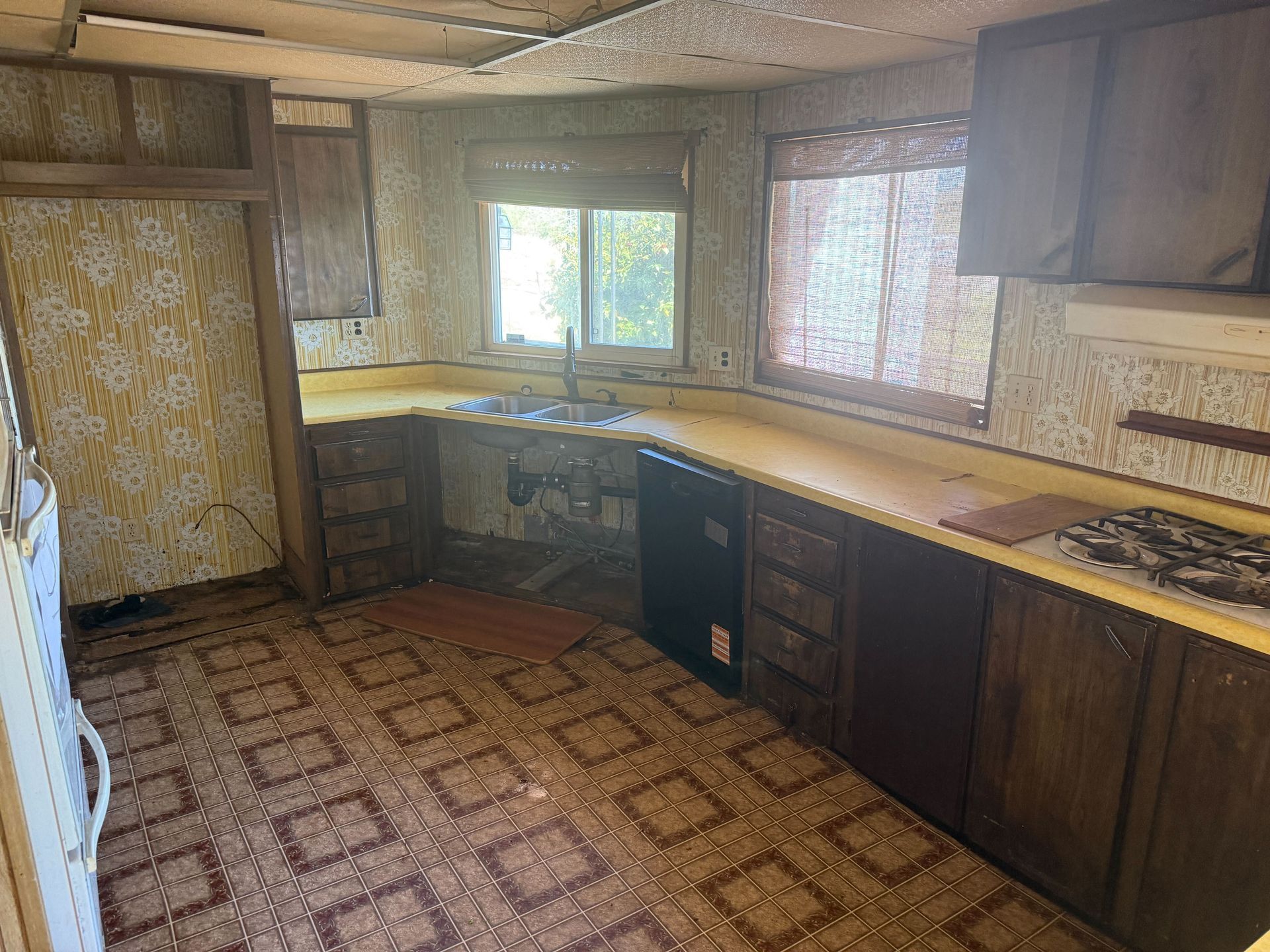 Hoarder cleanout in Gridley, CA — after: clean kitchen with wooden cabinets and clear counters