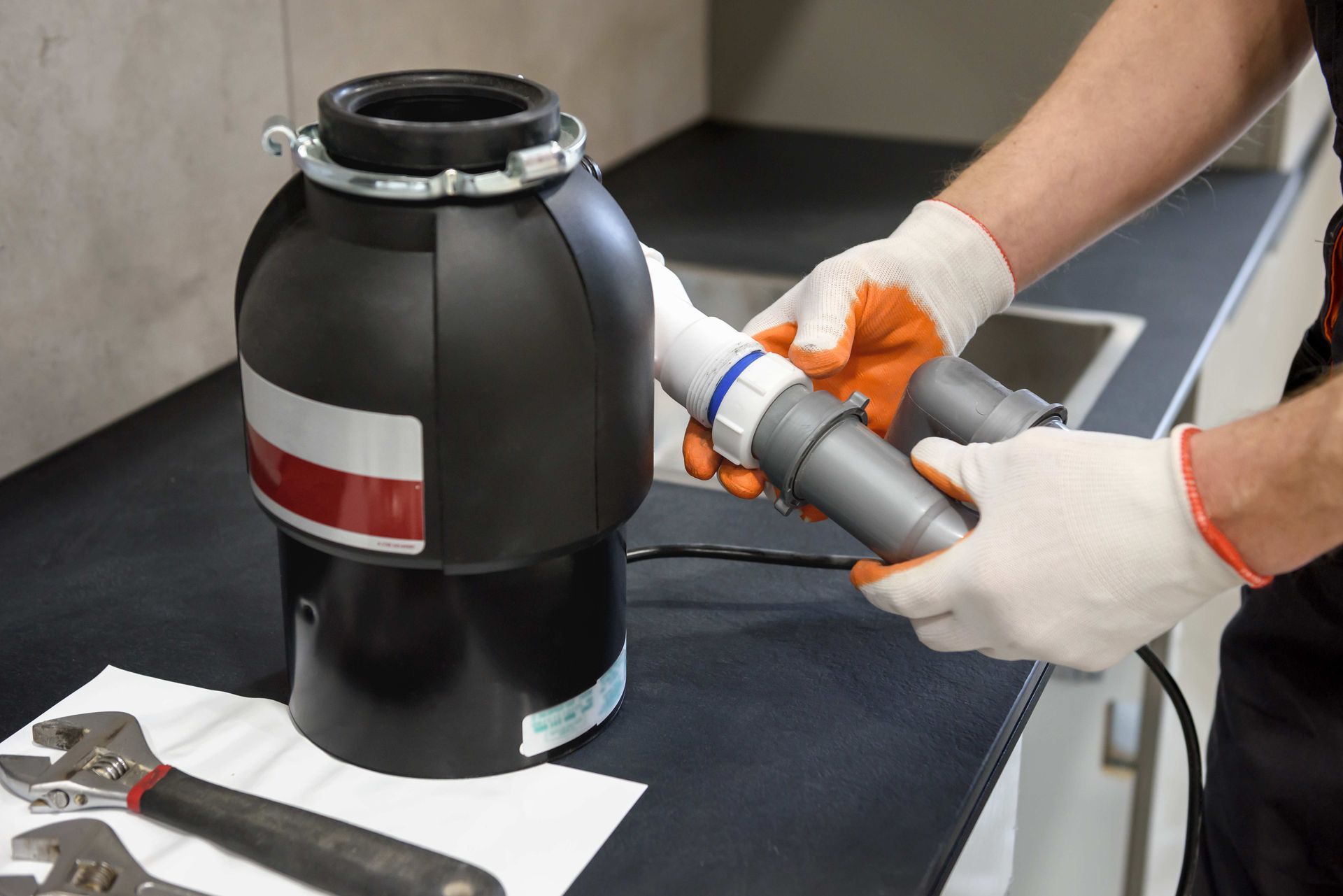 a man is fixing a garbage disposal in a kitchen