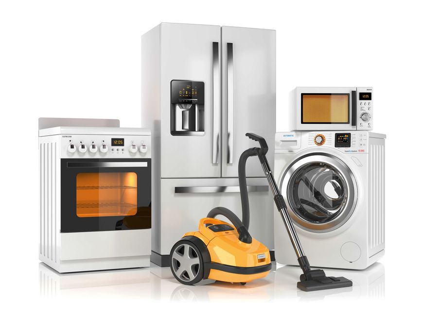 a refrigerator , stove , microwave , washing machine and vacuum cleaner are sitting next to each other