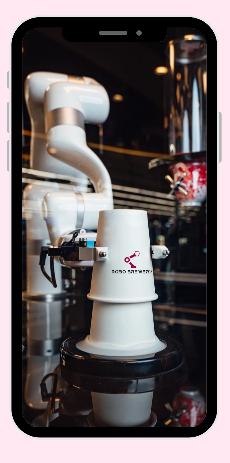 A robotic arm placing cups in a coffee machine.