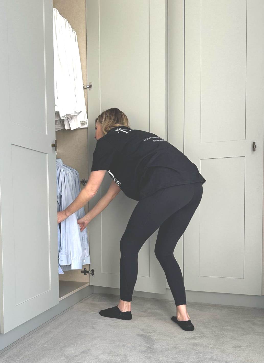 Professional unpacking service setting up a new home after moving day with organised boxes and practical storage.