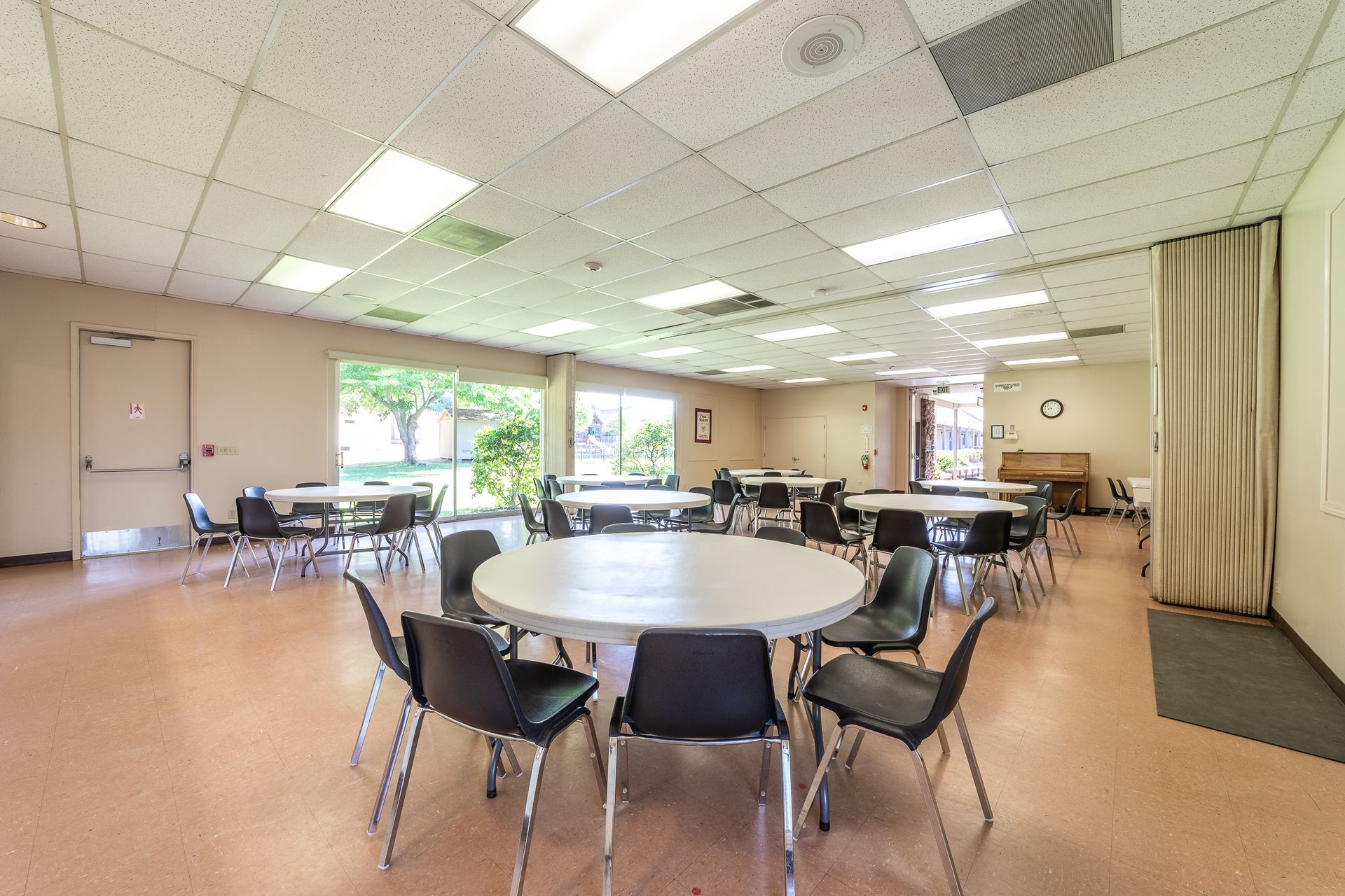 A large room with tables and chairs in it