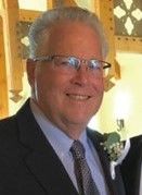 Bob Dennis is smiling for the camera.