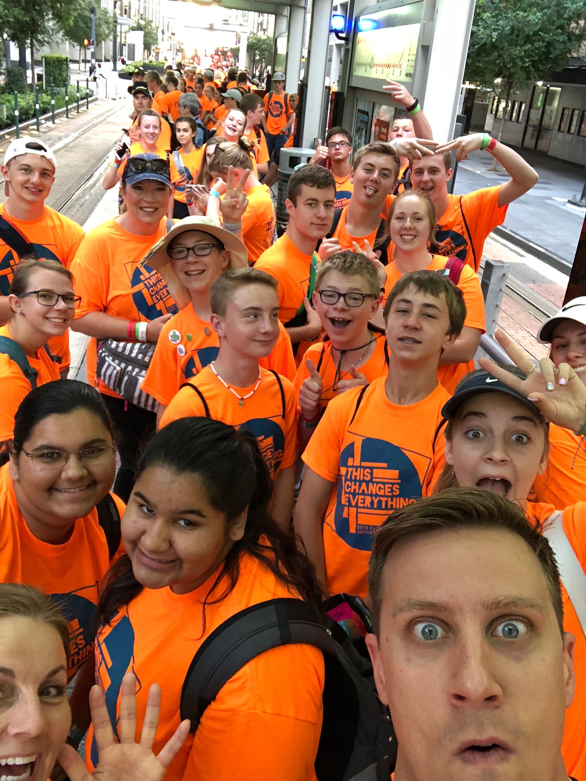 A group of youth wearing orange shirts with the word freedom on them