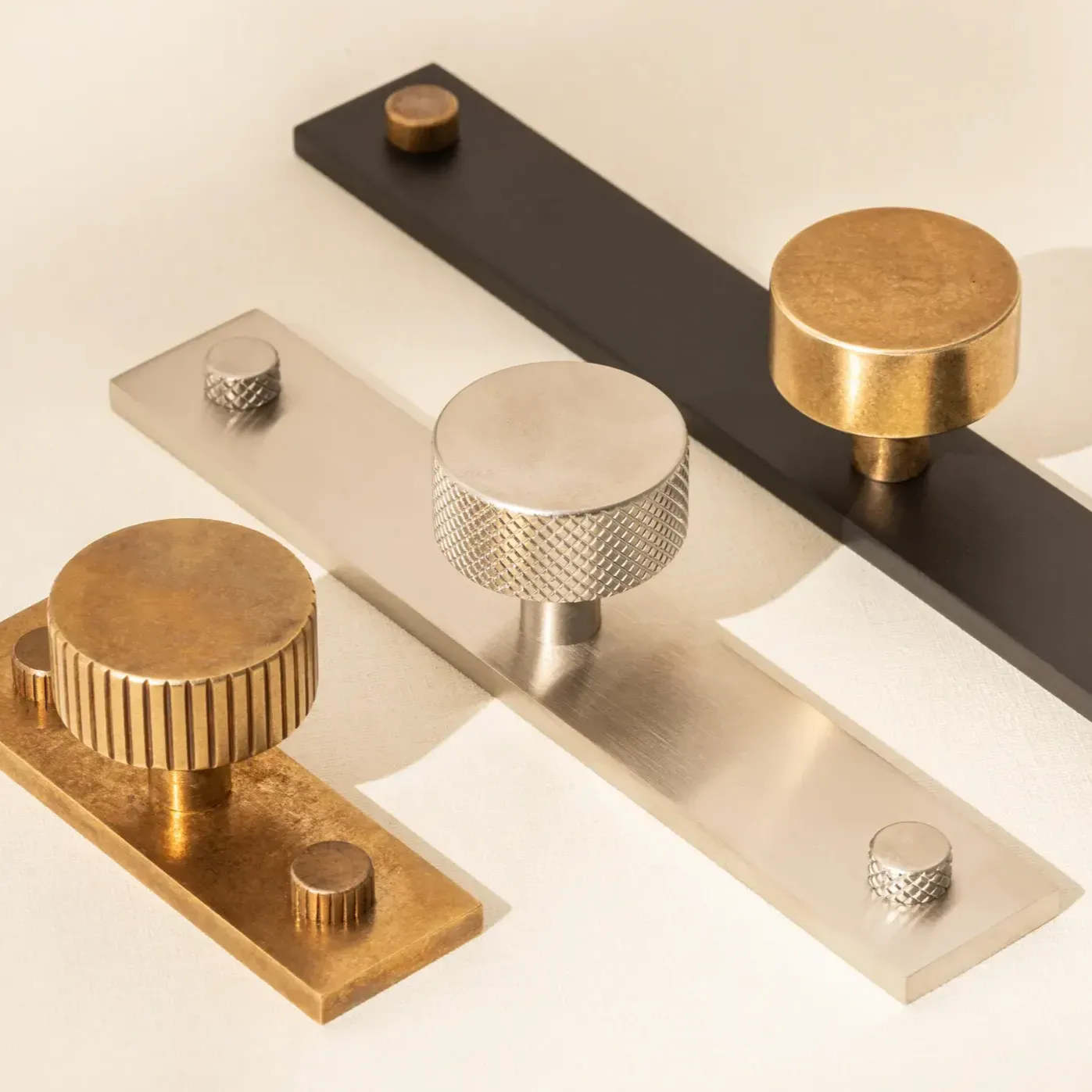 Three handles different sizes knurled patterns - brass, nickel and matt black with brass knob