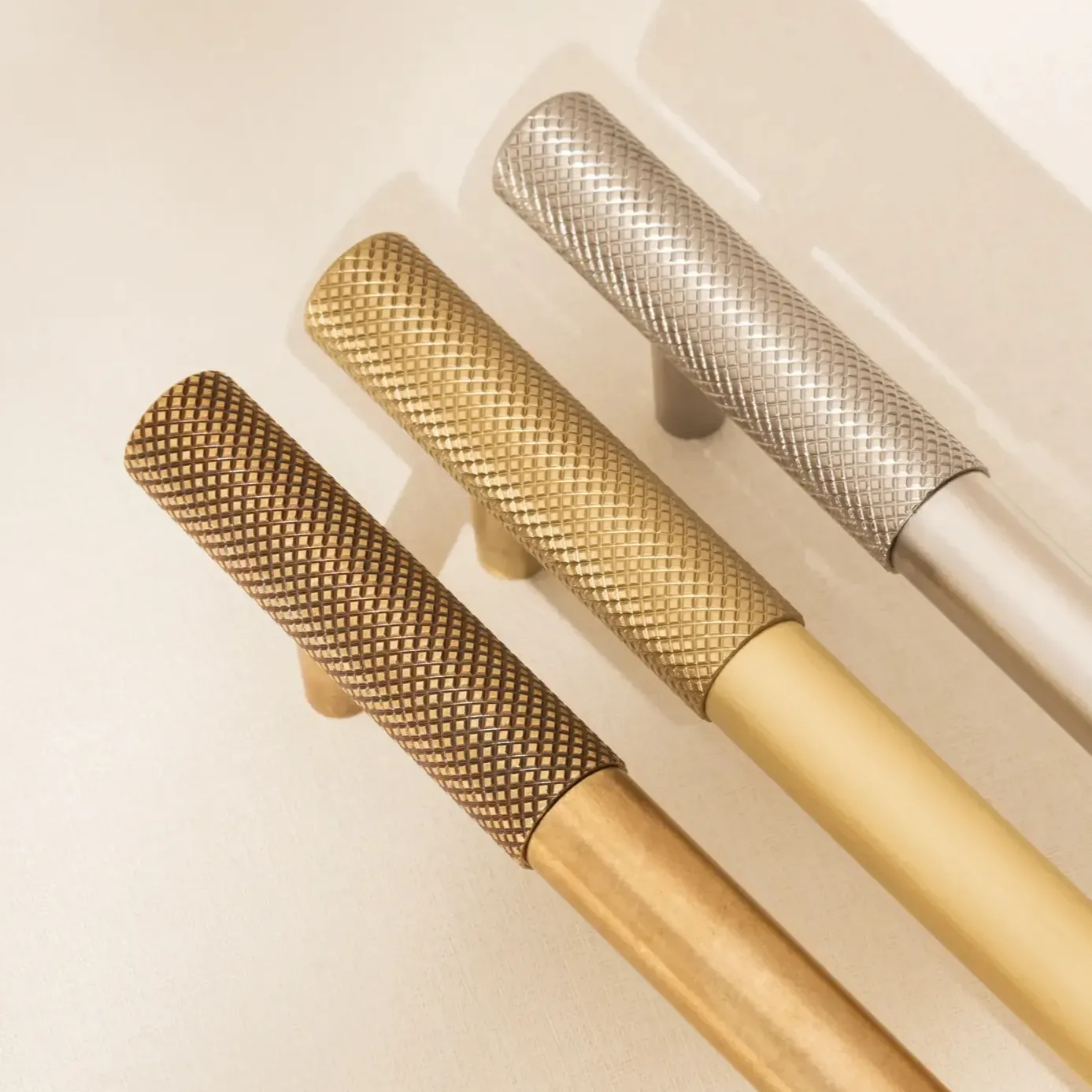 Three handles with finishes - burnished brass, satin brass and nickel