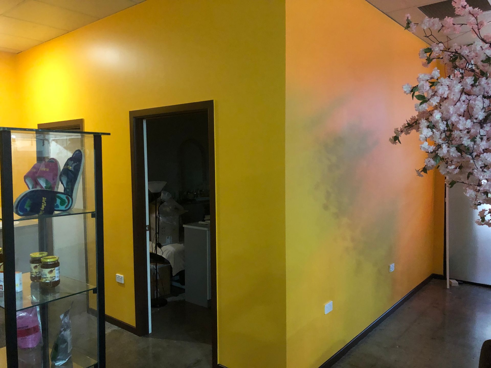 A man is standing on a ladder in a room.