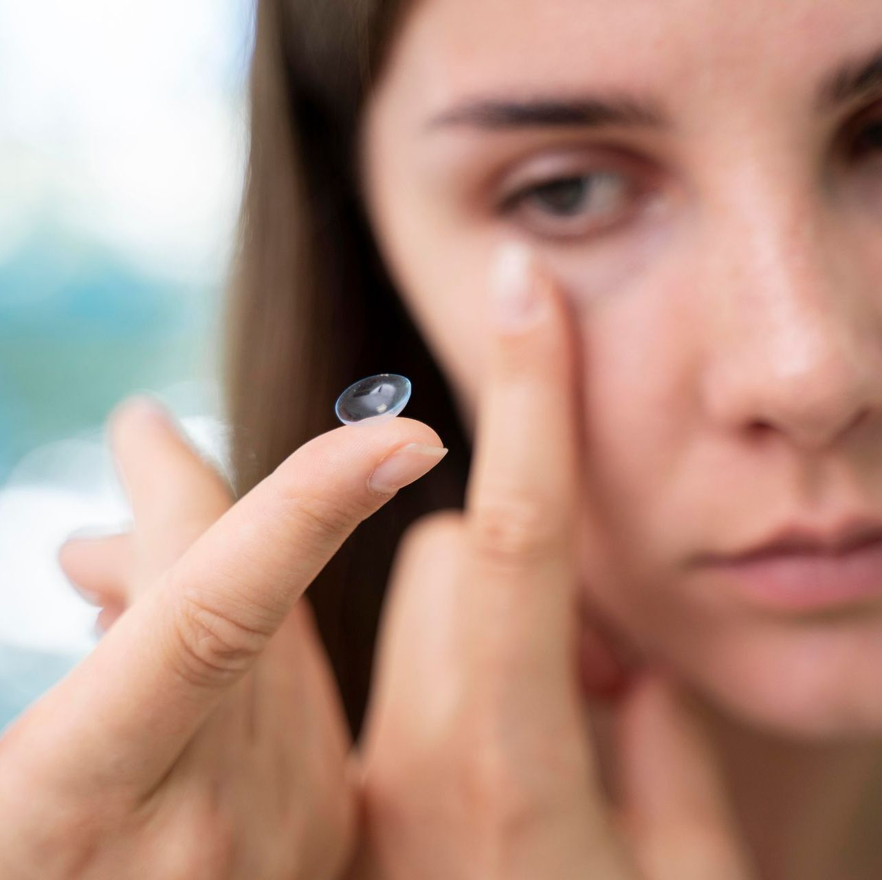 boy having light shone in eye for eye test