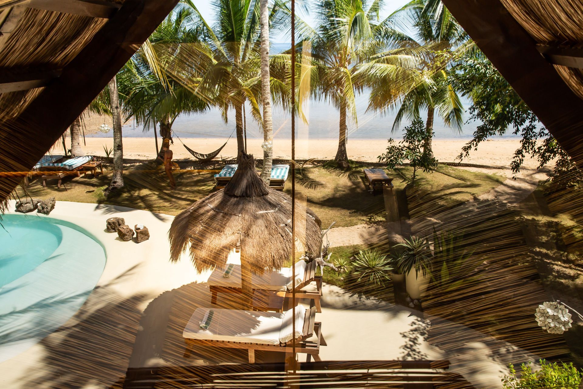 A view of a beach from the inside of a house