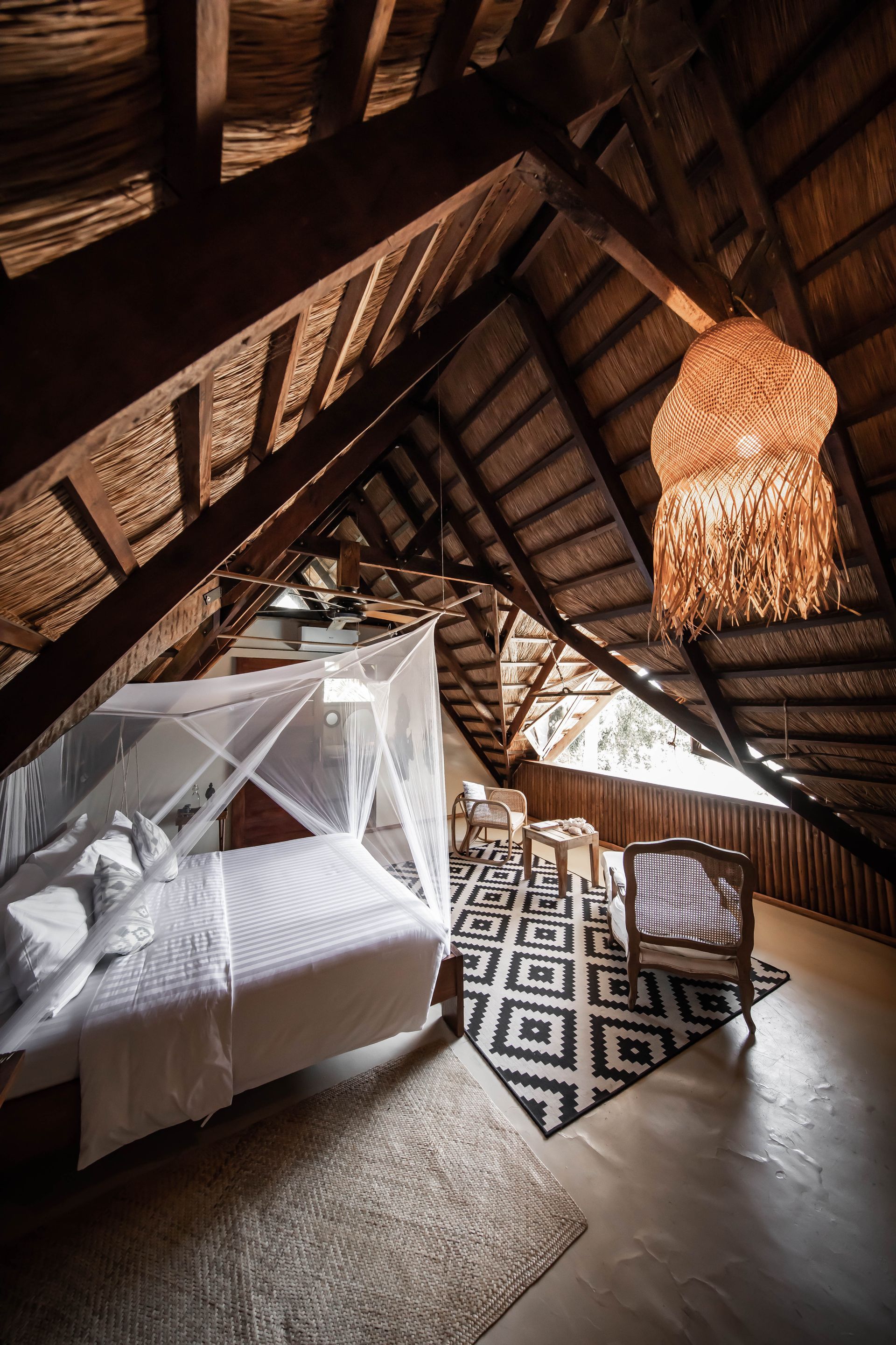 There is a bed in the attic with a mosquito net.