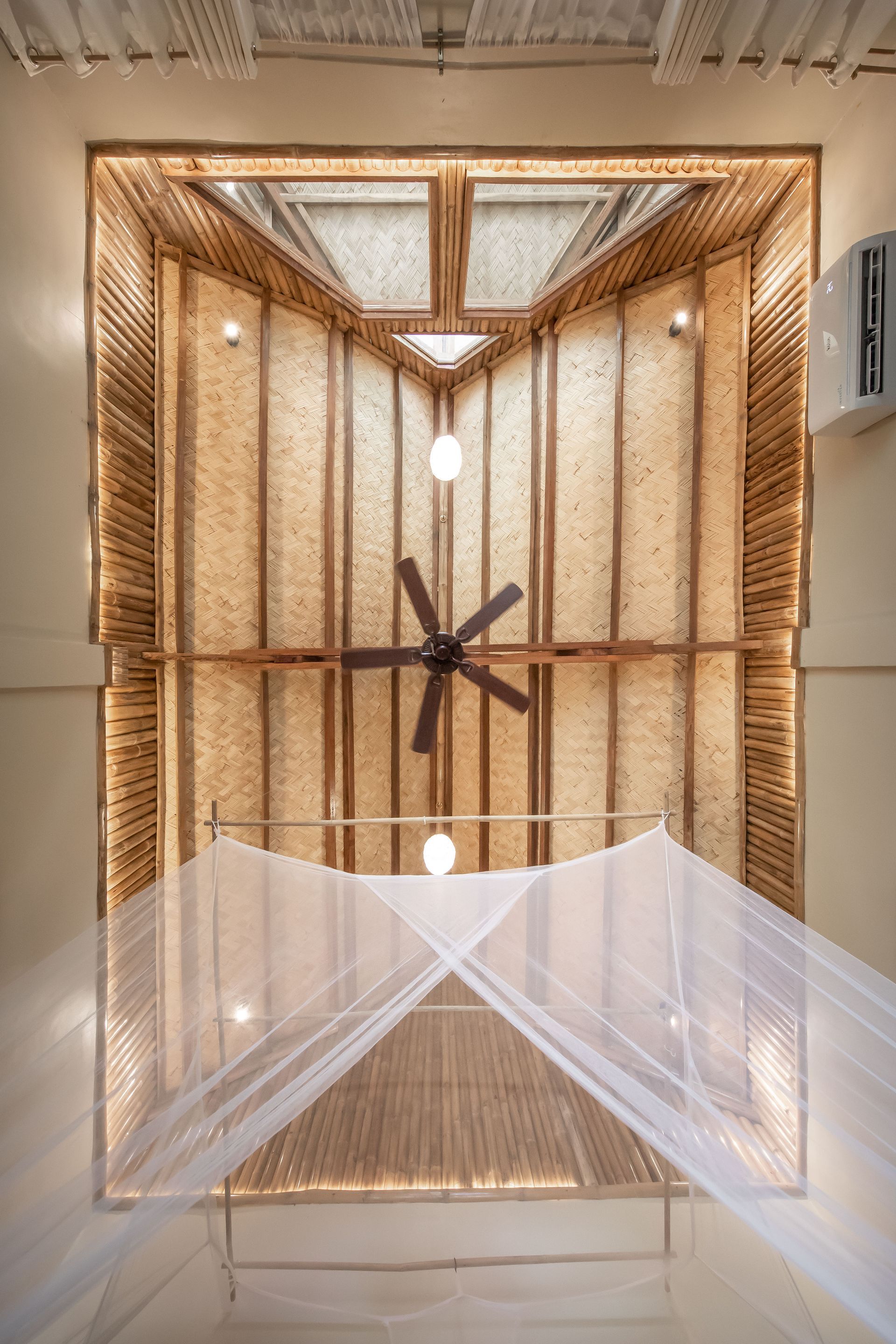 A bedroom with a canopy and a ceiling fan.