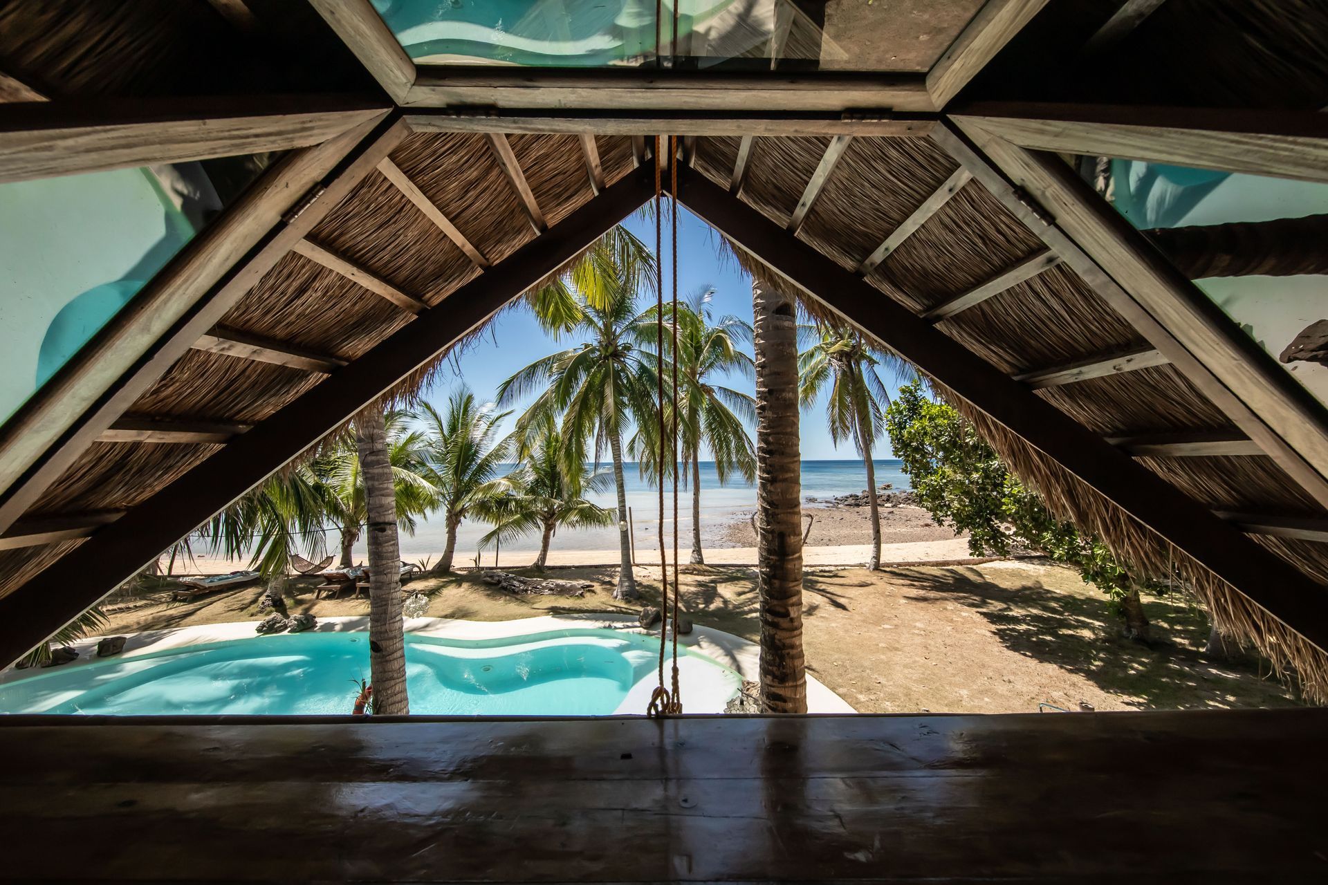 A view of a swimming pool from the attic of a house