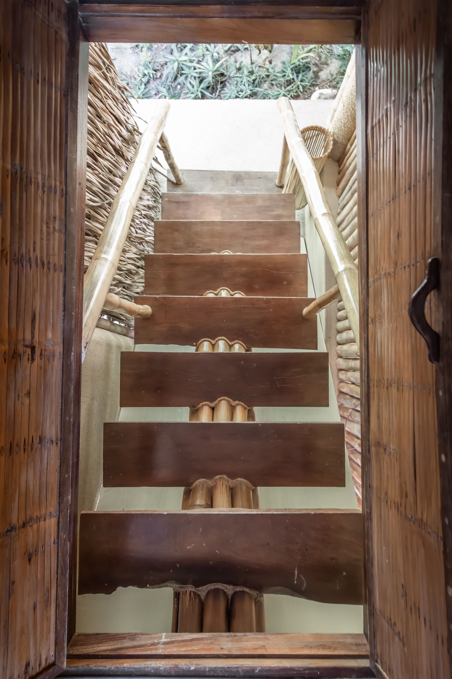 A set of wooden stairs leading up to a house.