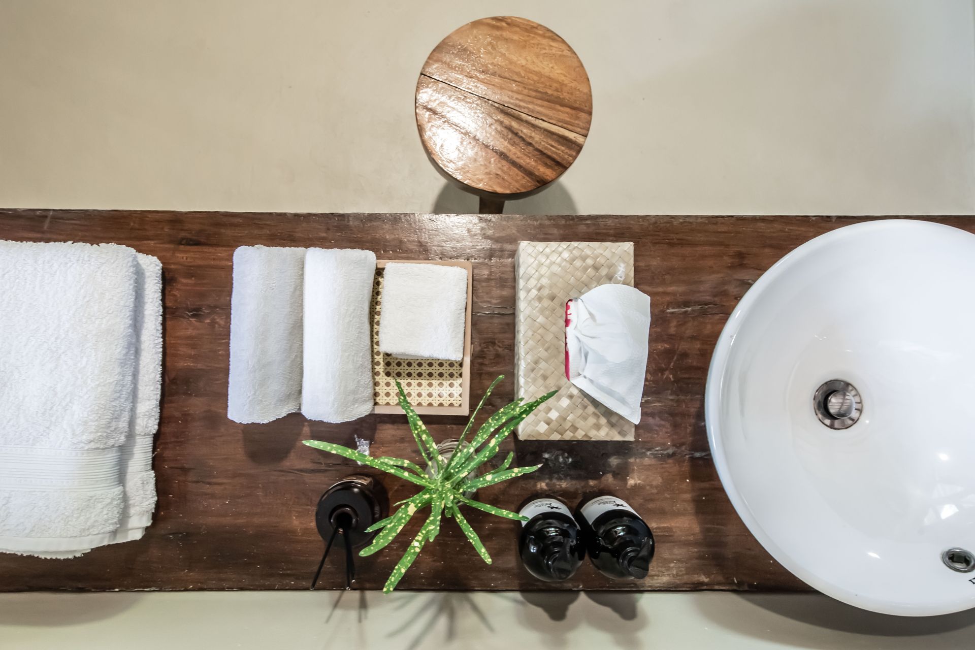 A bathroom counter with a sink and towels on it.