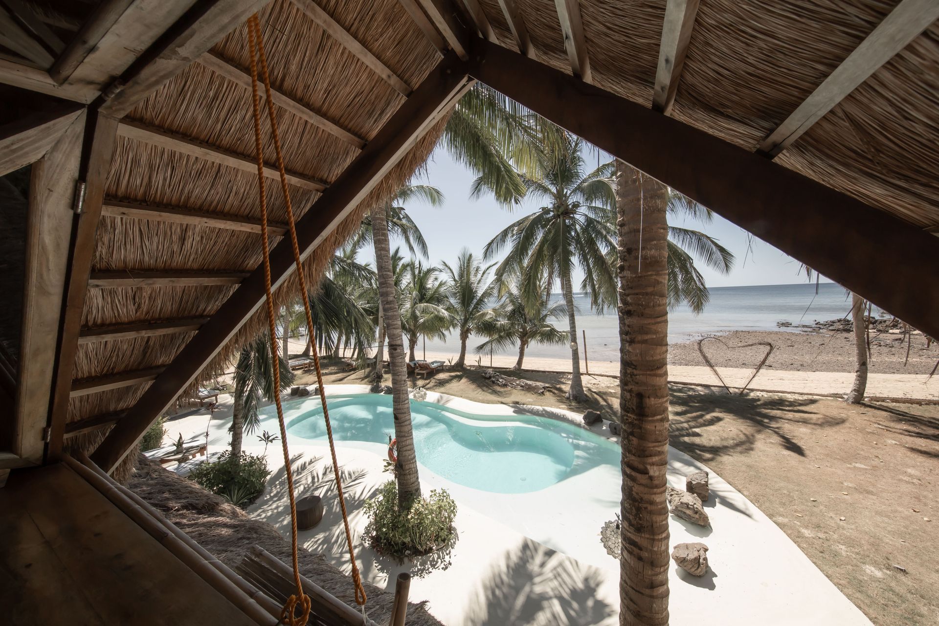 A view of a swimming pool with palm trees in the background