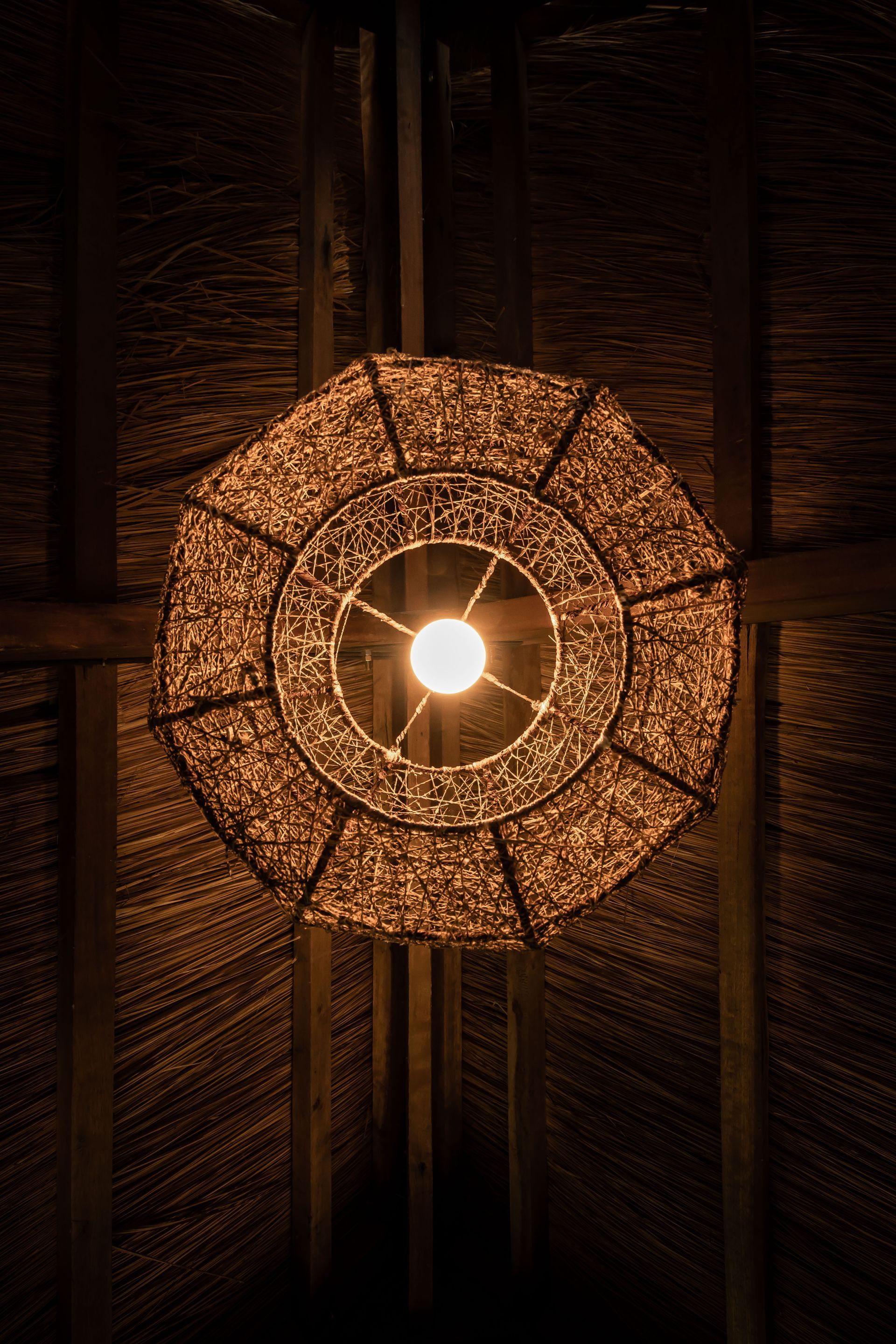 A lamp is hanging from the ceiling in a dark room.